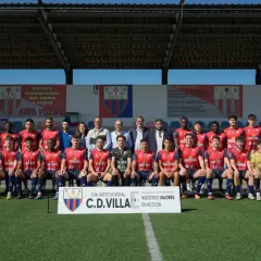 El equipo de fútbol C.D. Villa posa para una foto grupal en el campo.