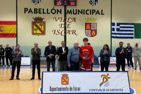 Joven jugador de baloncesto recibe trofeo en el Pabellón Municipal de Íscar.