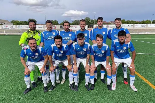 El equipo de fútbol Atlético Cervantino posa en el campo, con camisetas azules y blancas.