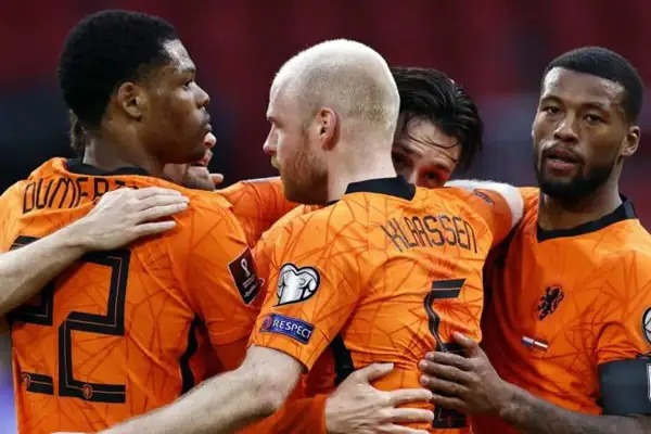Jugadores de la selección de Países Bajos celebran un gol. La camiseta naranja con el número 22 y 5 visible, parte de la liga de fútbol.